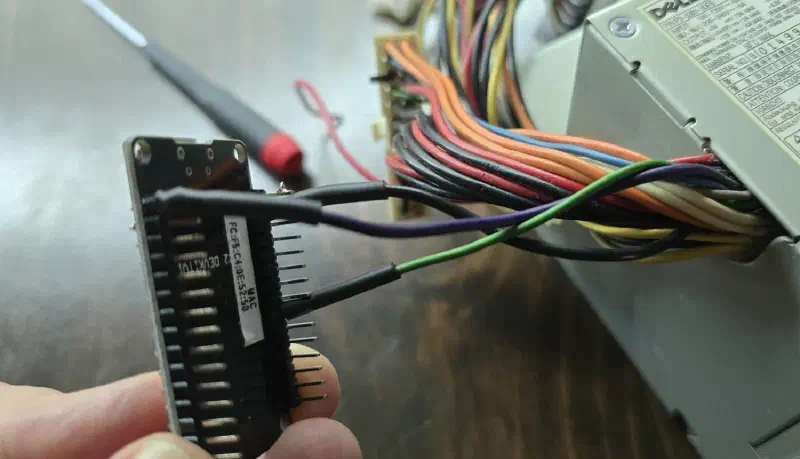 The three wires soldered to the ESP32 header, running into the ATX harness